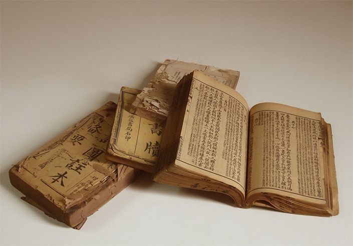 a pile of old books written using Chinese characters