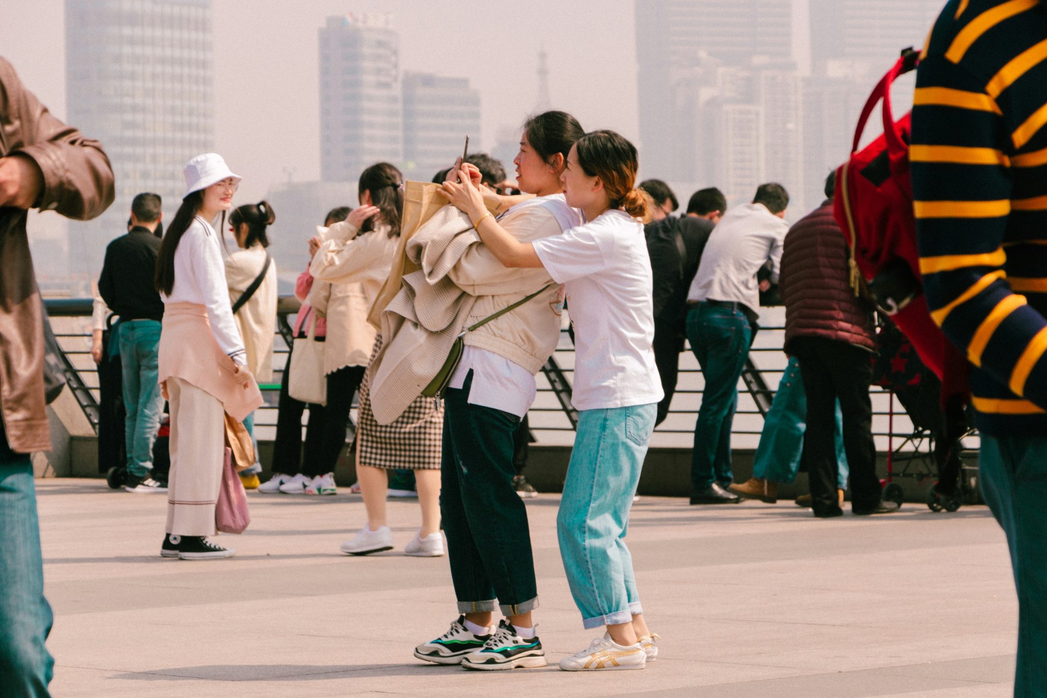 A crowded street scene in a Chinese city with red lanterns and traditional architecture