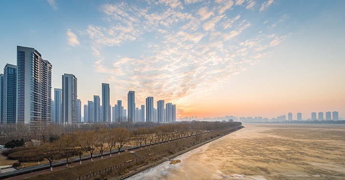 modern apartment buildings next to the sea at dawn in Shenyang, China