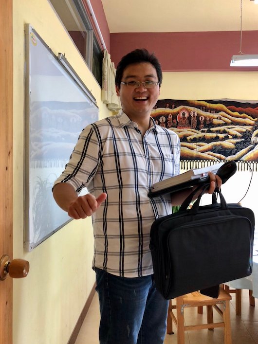a CLI teacher smiling and giving a thumbs up sign