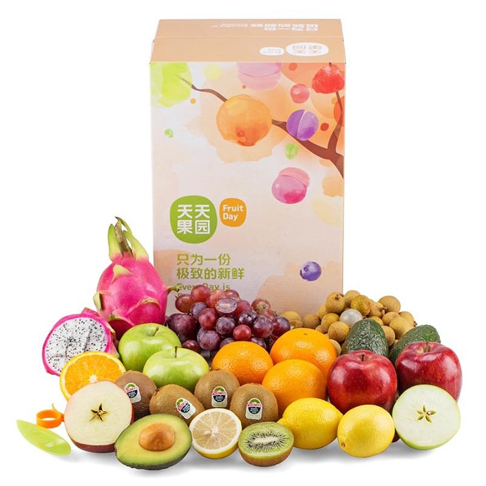 a selection of fruit sits in front of a Chinese gift box
