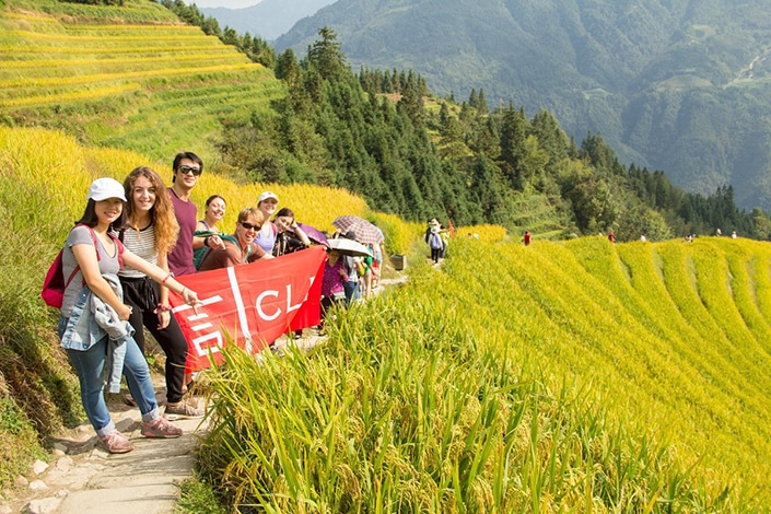 CLI students stand together in the rice terraces of a village near Guilin