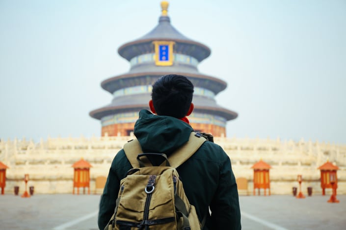 站在中国北京天坛前的年轻旅行者。 亚洲旅游