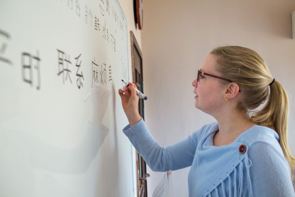 Student writing on a white board