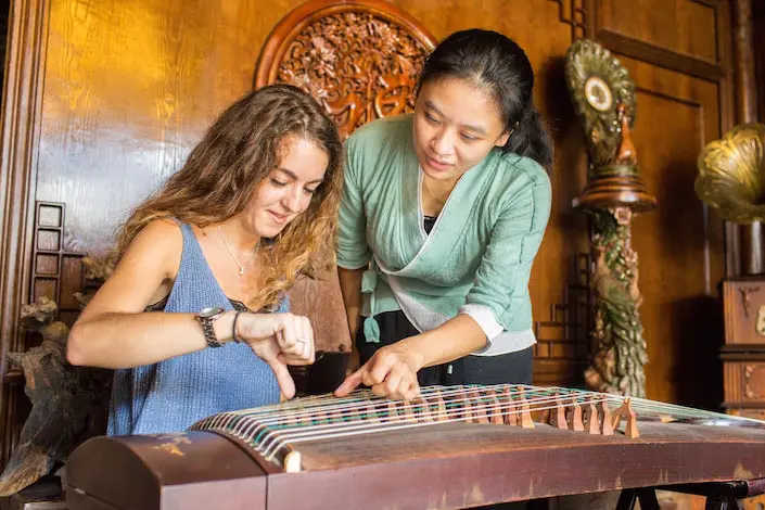 Students learning Guzheng with Chinese teacher