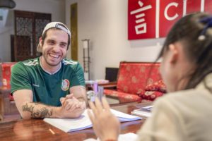 A student laughs during beneath the CLI sign