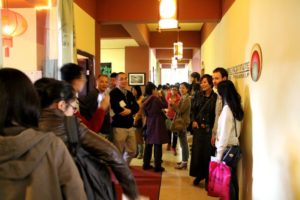 A crowd of visitors fills a Center hallway