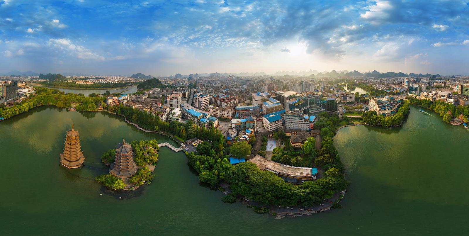 Guilin&rsquo;s Sun and Moon Pagodas, the lakes, and downtown from above, with limestone peaks on the horizon