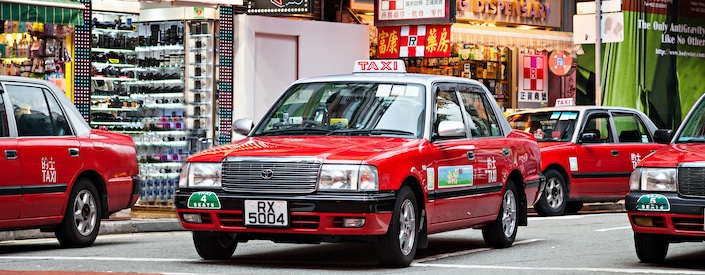 red taxis on street in hong kong