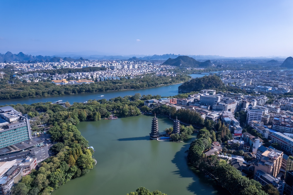 Stunning Aerial View of a City Surrounded by Lush Nature and Waterways