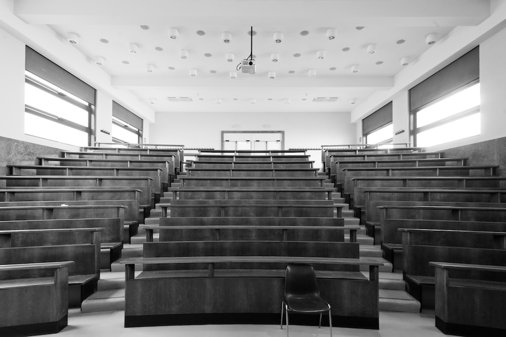Students sitting in a large university lecture hall during a group class