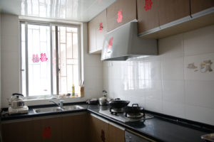 A tidy home kitchen with a stove and range hood