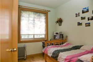 A host family bedroom with a bed by the window