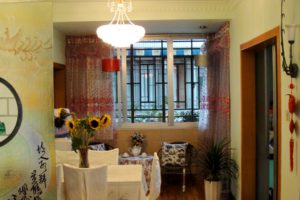 A home dining area with sunflowers and patterned curtains