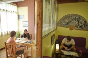 Students study at desks and on a sofa in a Center classroom