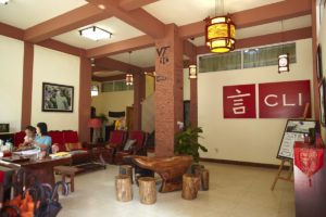 The CLI Center lobby with wooden furniture and a red CLI sign