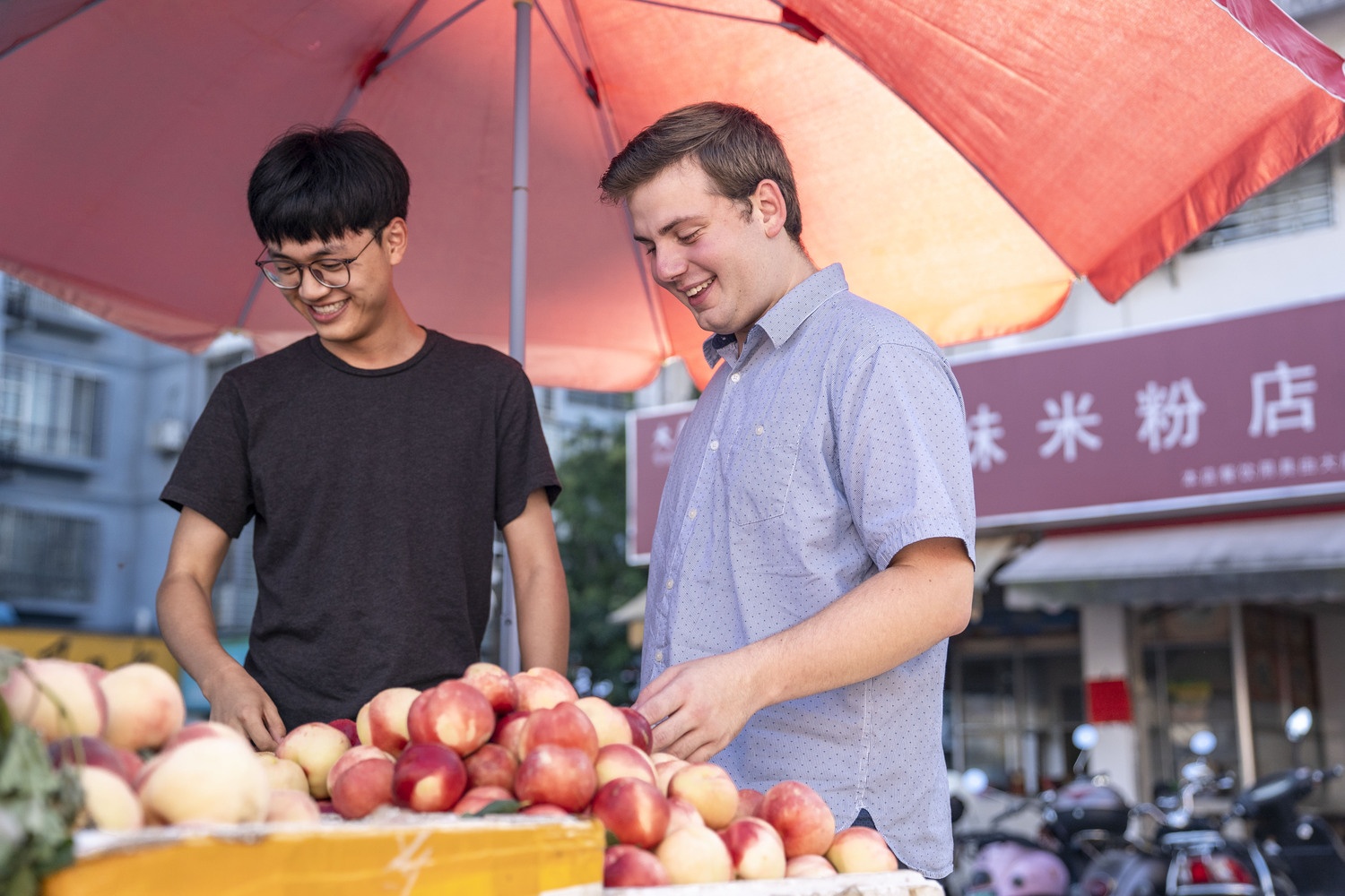 Students choosing peaches at a local market