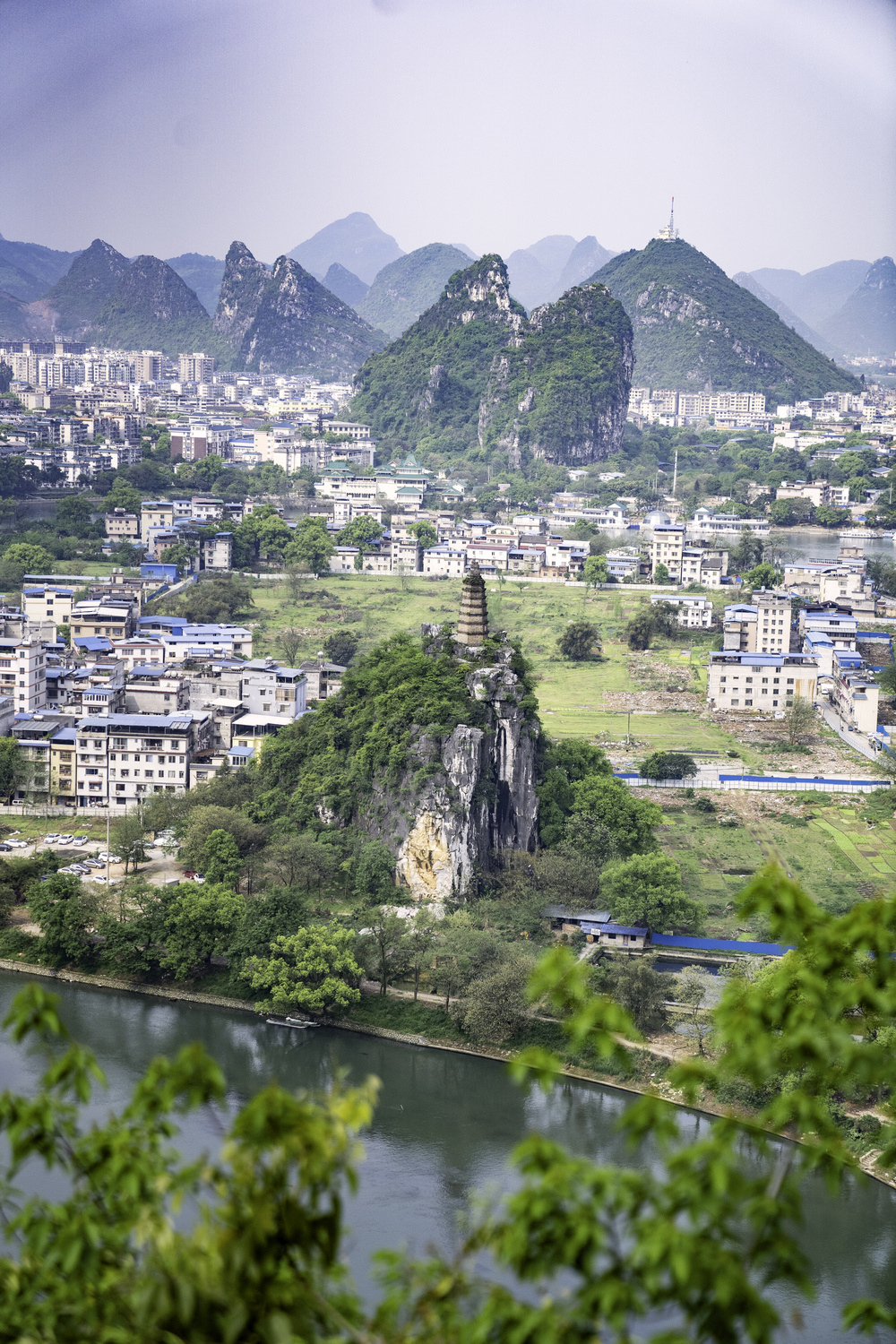 a city skyline framed by karst mountains in Guilin, China