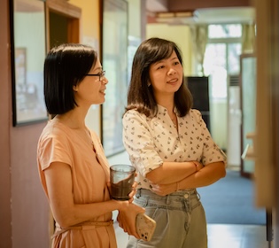 CLI team members conversing in a hallway