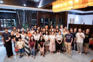 A large group poses together for a photo in a restaurant