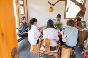 A small group takes part in a workshop in a rustic wooden room