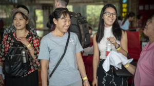 Guests smile as they arrive at an indoor event
