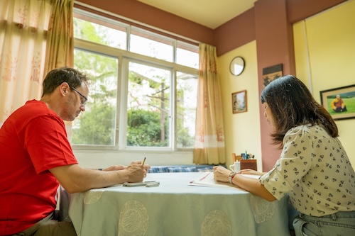 A CLI student practices writing Chinese characters during a one-on-one Mandarin lesson in Guilin, China.