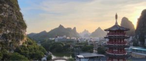 A pagoda and karst peaks glow at sunset over Guilin