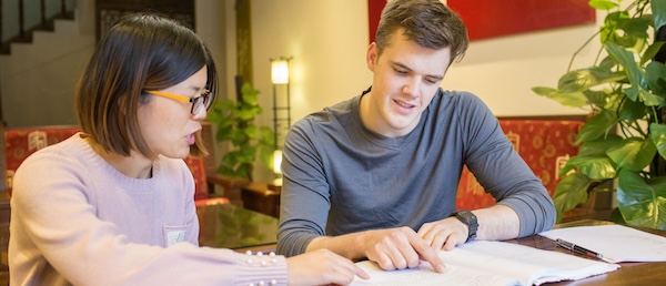 CLI student and teacher studying Chinese together at a table