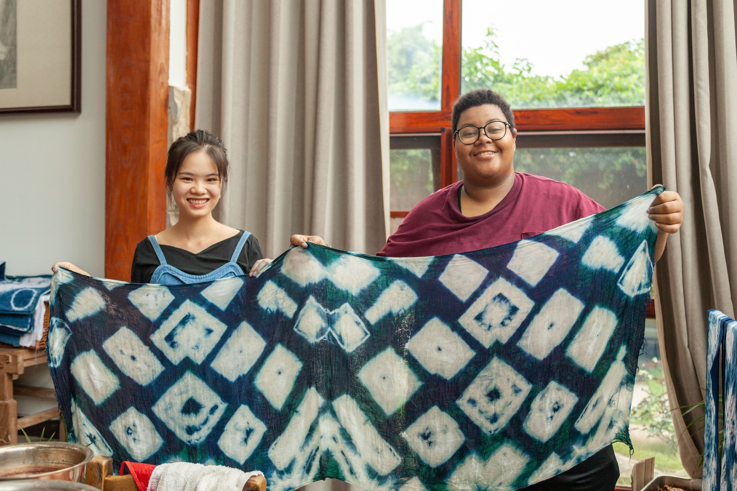 CLI students holding tie-dye creations