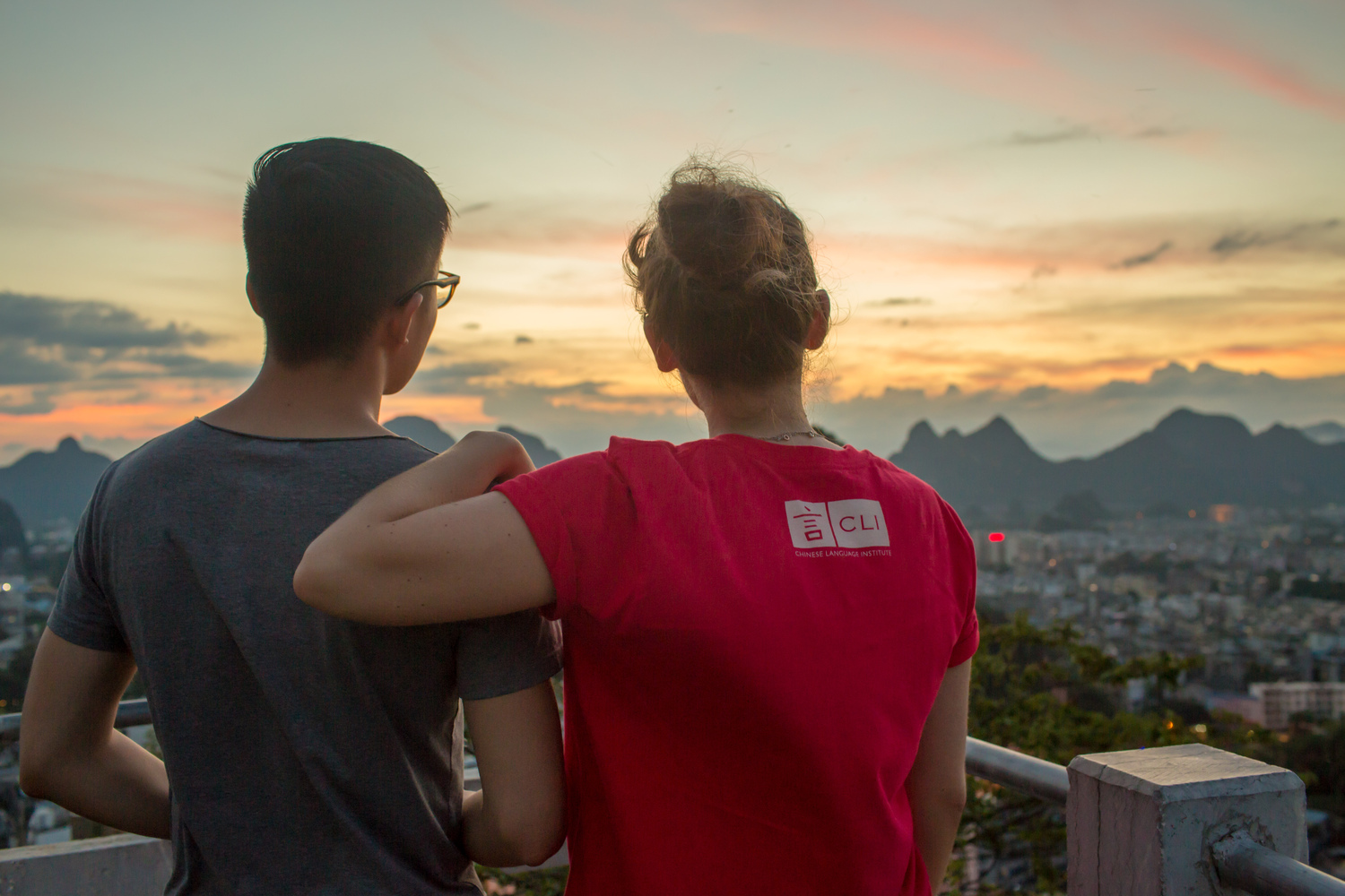Two CLI students watching the sunset over Guilin from a hilltop
