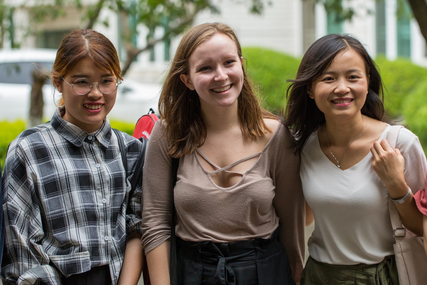 Three women smiling outdoors