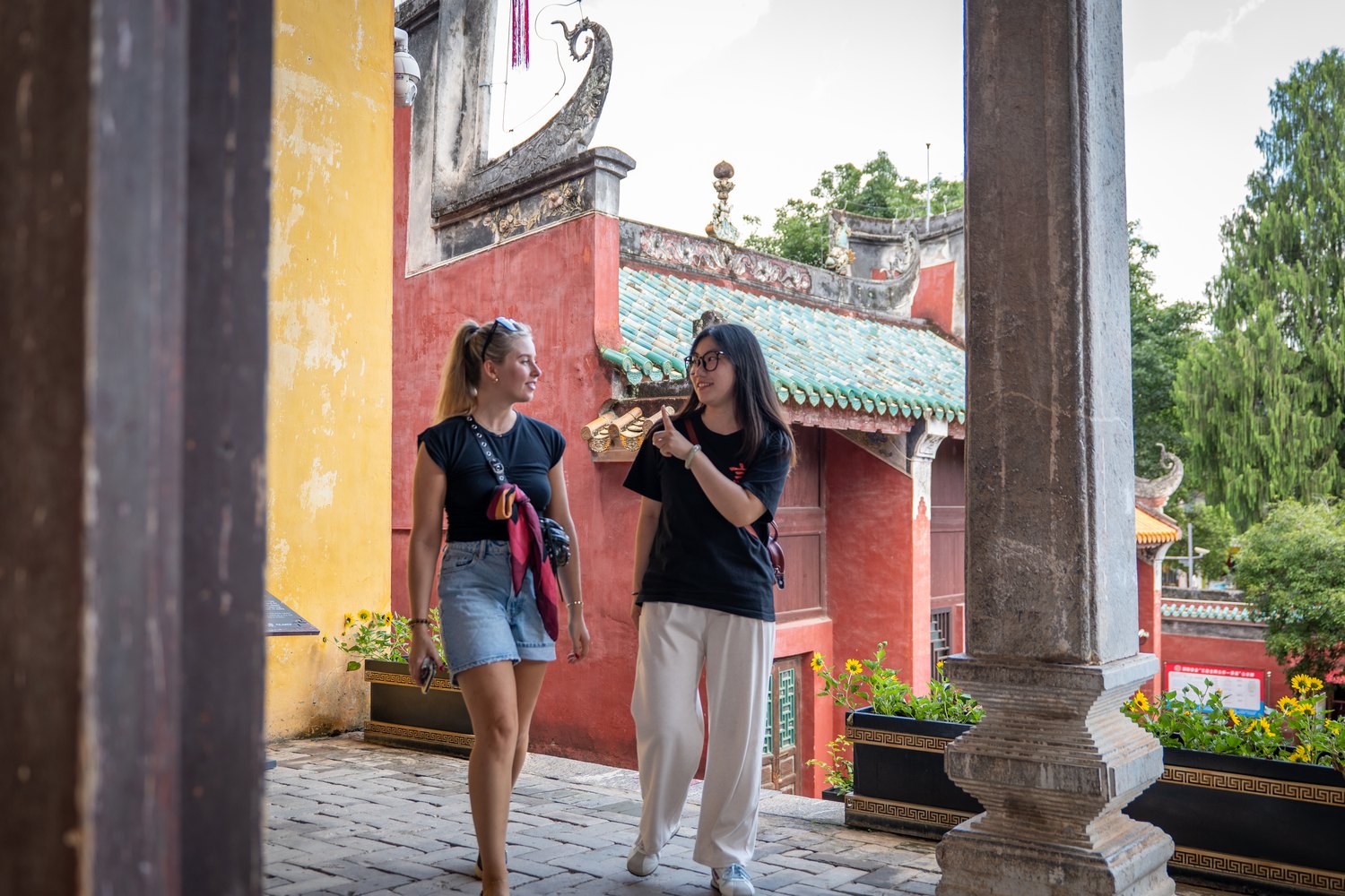 Two CLI students in a temple courtyard