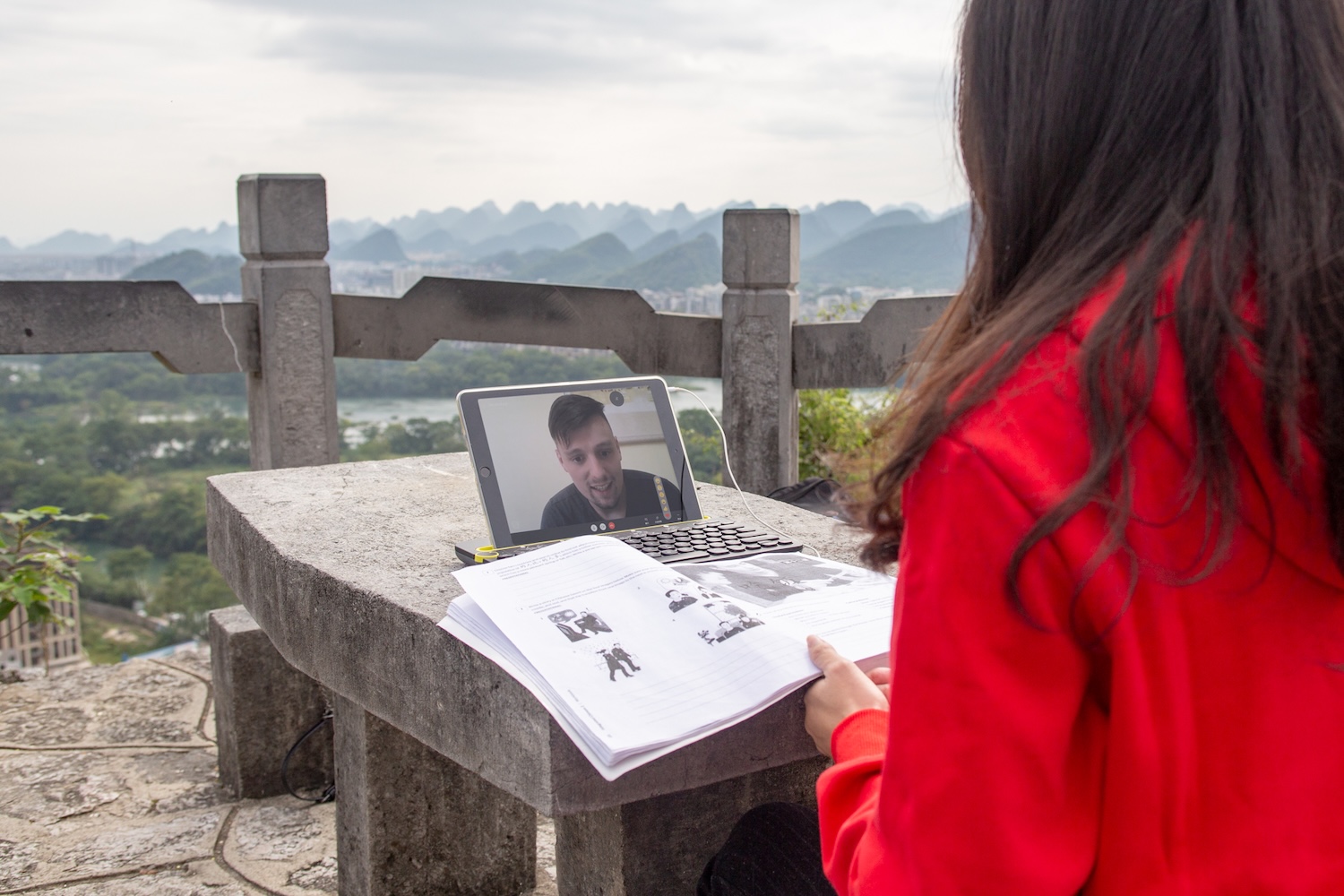 CLI teacher holding online one-on-one outdoors with her student who is on an iPad screen